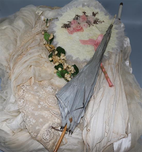 A Victorian silk and lace wedding dress and two parasols
